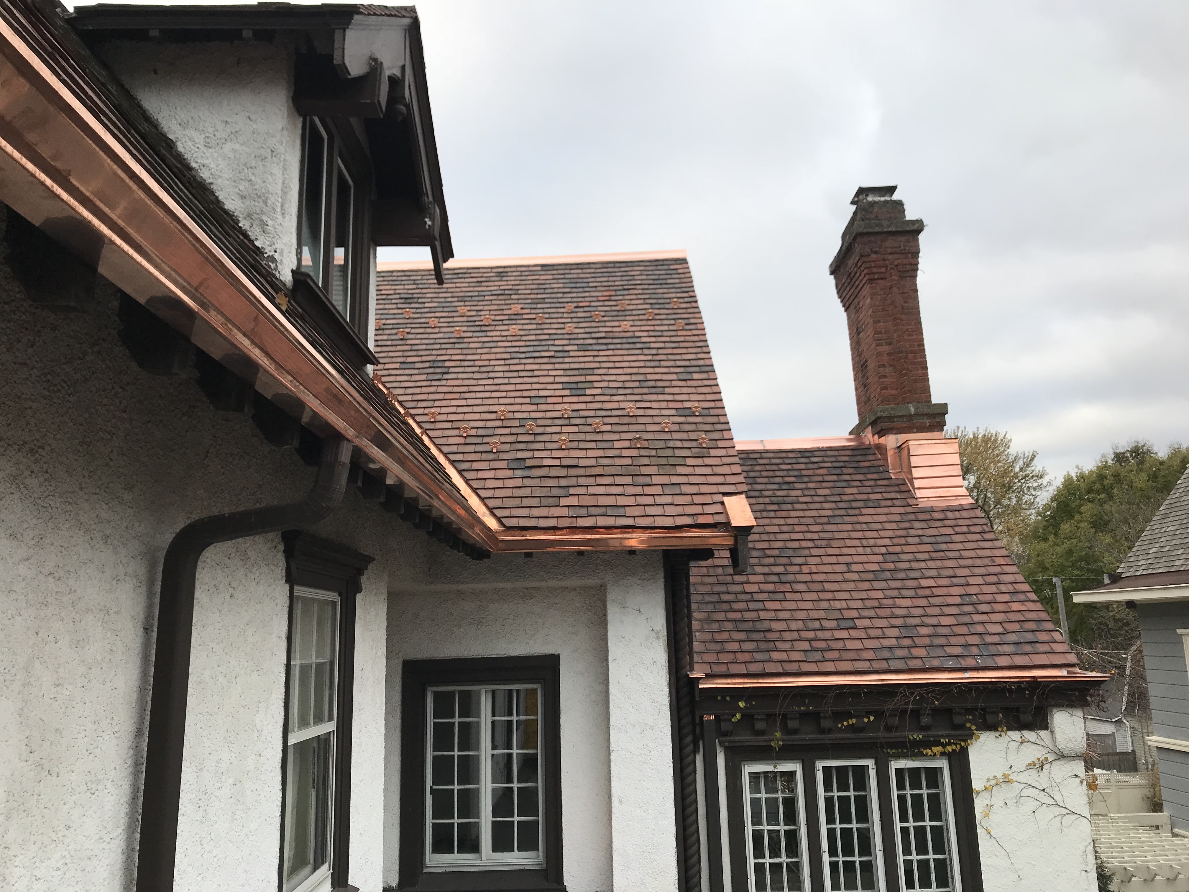 Evanston New Tile Roof with Copper Valley, Gutter and Snow Guards