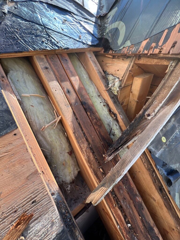 Copper roof repair with close up of rotted wood damage